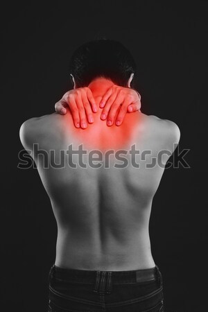 Rear view of a young man suffering from backache Stock photo © deandrobot