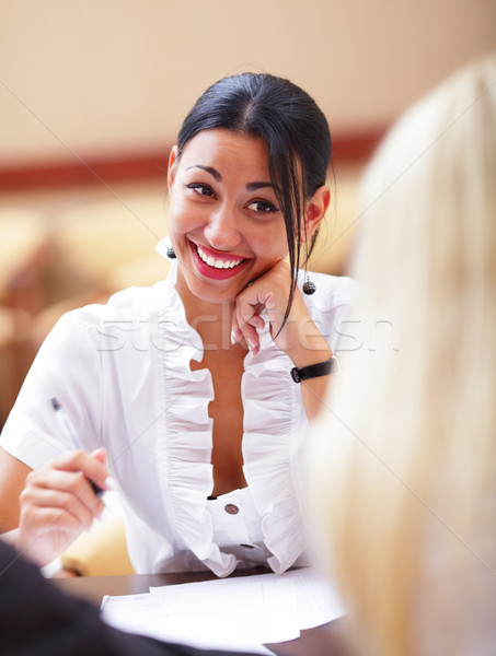 Risonho mulher sessão reunião de negócios colegas escritório Foto stock © deandrobot