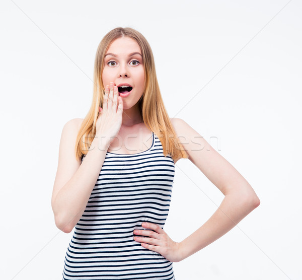 Stock photo: Surprised young woman staring at camera