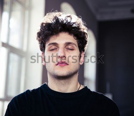 Portrait of a handsome young man looking at camera Stock photo © deandrobot