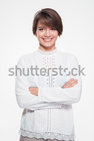 Beautiful happy young woman standing with crossed arms Stock photo © deandrobot