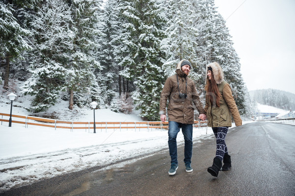 Couple laughing and walking on the road together in winter Stock photo © deandrobot