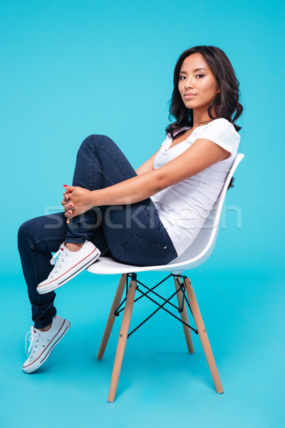 Portrait of a casual vietnamese woman sitting on the chair Stock photo © deandrobot