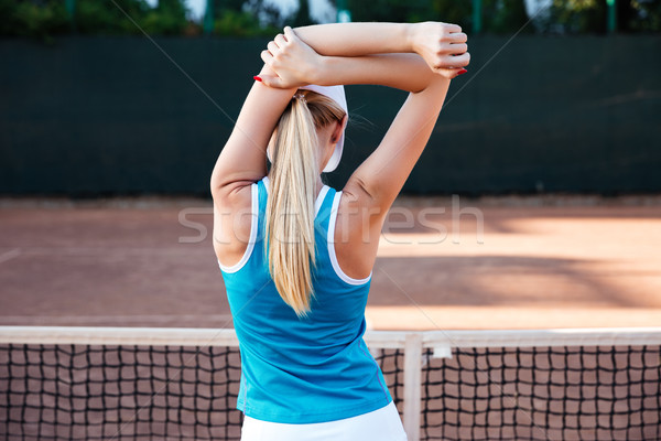 Stretching sports woman or tennis player warming up Stock photo © deandrobot