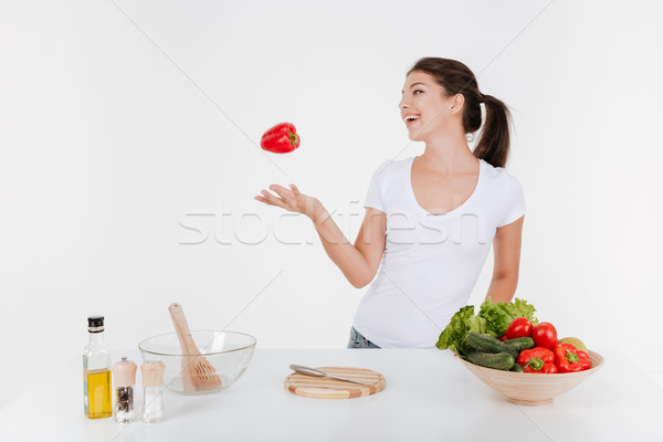 Happy woman cooking with vegetables Stock photo © deandrobot