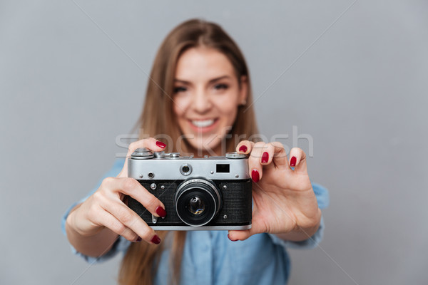 Smiling Woman in shirt making phone on retro camera Stock photo © deandrobot