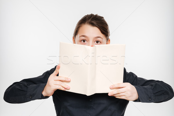 Happy young girl reading book Stock photo © deandrobot