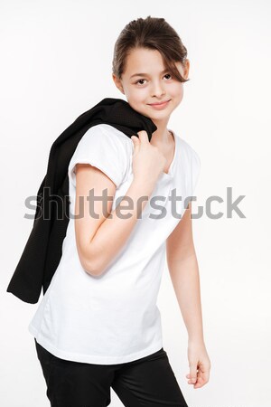 Happy young girl posing isolated over white background. Stock photo © deandrobot