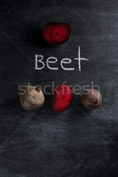 Top view photo of a cut beet over chalkboard background Stock photo © deandrobot