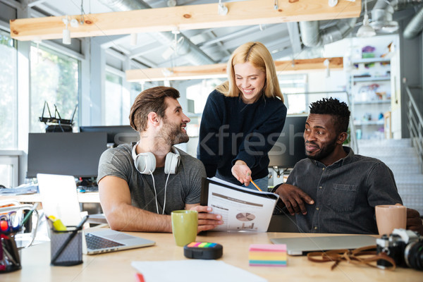 Happy young colleagues in office coworking Stock photo © deandrobot