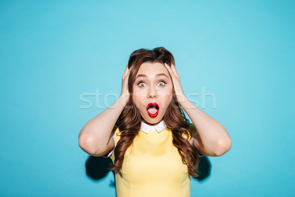 Portrait of a surprised shocked woman in dress Stock photo © deandrobot