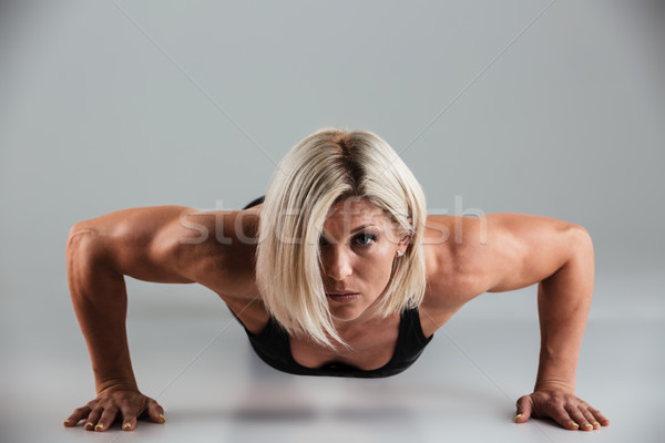 Stock photo: Portrait of a concentrated muscular adult sportwoman