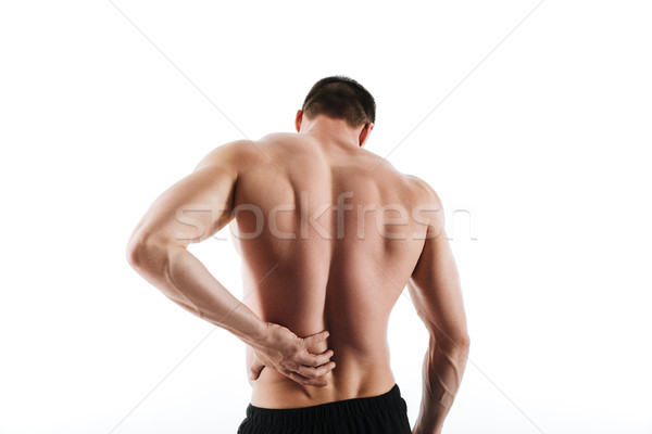 Back view of sportsman have a painful feelings in body. Stock photo © deandrobot