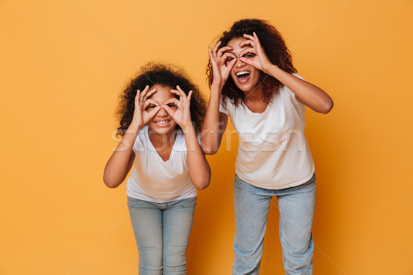 Portrait of two smiling african sisters Stock photo © deandrobot