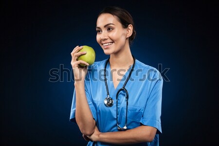 Happy healthy doctor holding green apple isolated Stock photo © deandrobot
