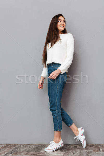 Stock photo: Full length photo of young charming brunette woman with long hai