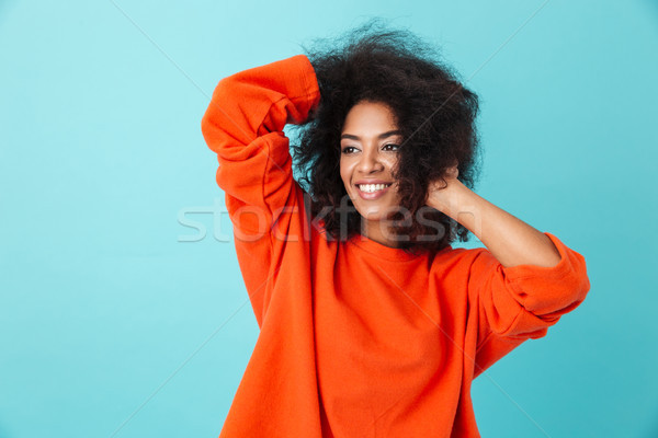 Colorful portrait of american woman in red shirt looking aside w Stock photo © deandrobot