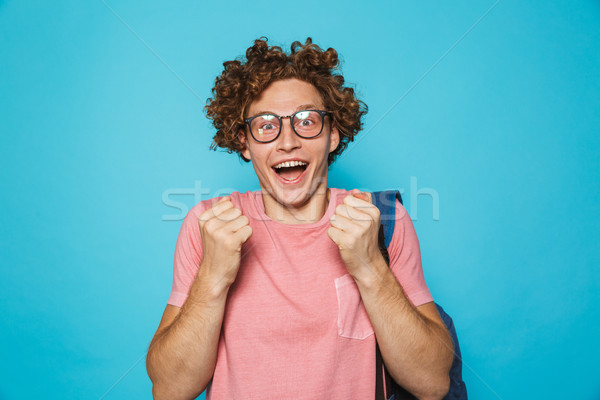 Image of excited goggles guy with curly hair wearing glasses and Stock photo © deandrobot