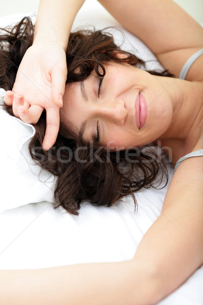 Beautiful woman lying on the bed and smiling Stock photo © deandrobot