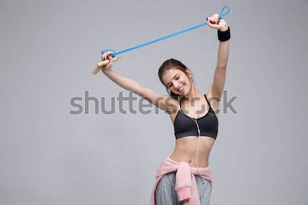 Happy sporty woman using smartwatch Stock photo © deandrobot