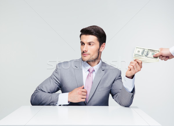 Businessman taking bribe Stock photo © deandrobot