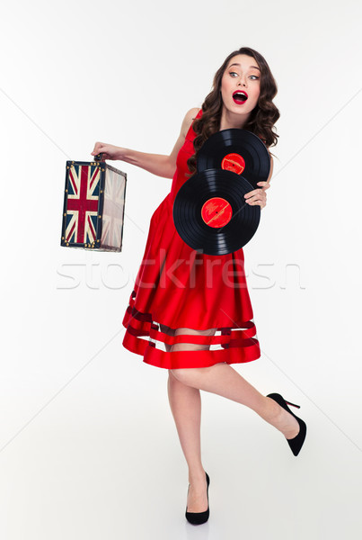 Curly woman running on high heels with vintage suitcase  Stock photo © deandrobot