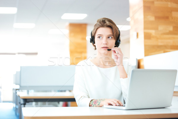 Beautiful young woman with headset working in call center  Stock photo © deandrobot