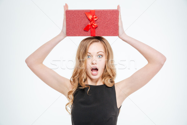 Amazed woman holding gift box  Stock photo © deandrobot