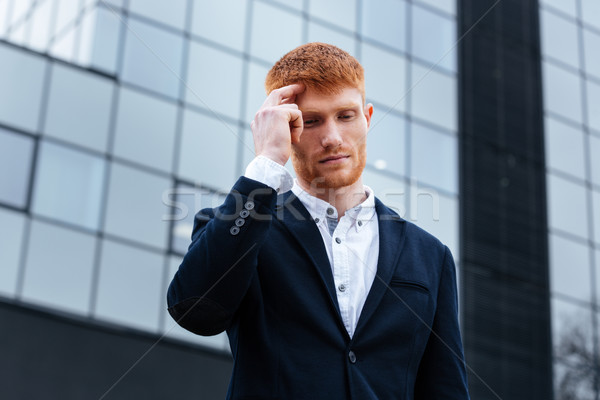 Businessman thinking about something outdoors Stock photo © deandrobot