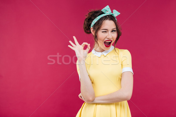 Felice attrattivo pinup ragazza giallo abito Foto d'archivio © deandrobot