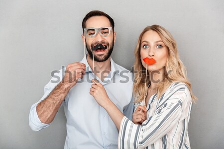 Mad criminal man threatening to scared young woman with gun Stock photo © deandrobot