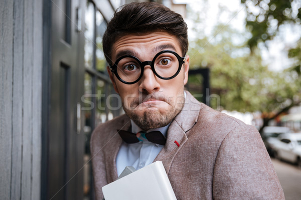 Close-up portrait of a funny nerd man wearing eyeglasses Stock photo © deandrobot