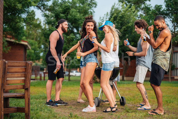 Stock photo: Happy young friends dacing and having fun outdoors