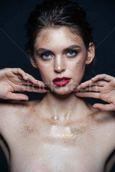 Beauty portrait of attractive young woman with sparkles on face Stock photo © deandrobot