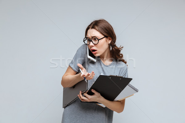 Shocked Female nerd talking on phone Stock photo © deandrobot