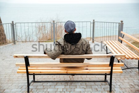 Back view picture of young african man on a bench Stock photo © deandrobot