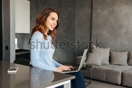 Businesswoman talking on mobile phone while sitting on the couch Stock photo © deandrobot