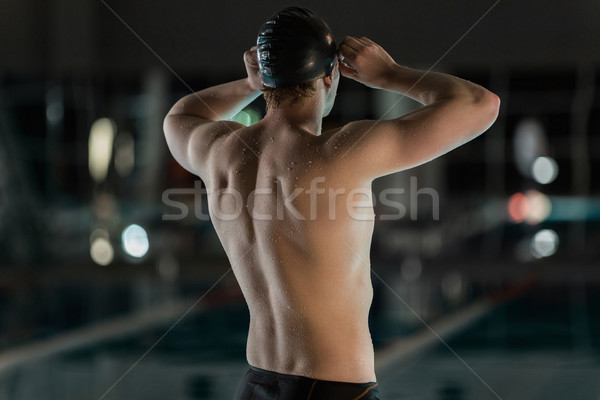 Rear view of a male swimmer Stock photo © deandrobot
