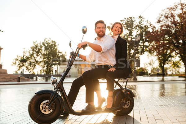 Full length side view image of happy business couple Stock photo © deandrobot