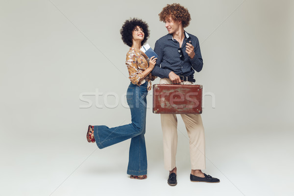 Retro loving couple make holding suitcase passport and tickets. Stock photo © deandrobot