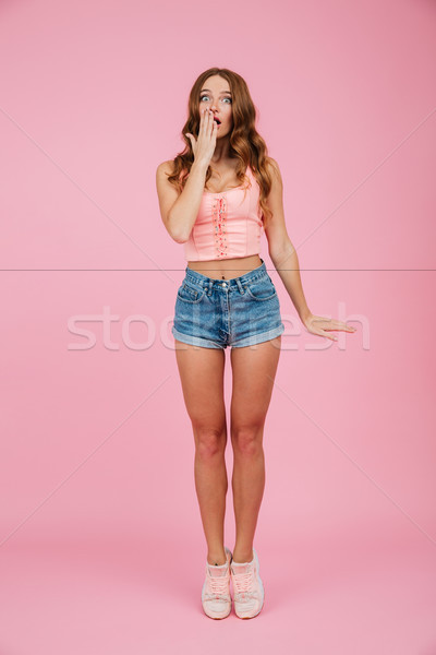 Full length portrait of a shocked pretty woman in summer clothes Stock photo © deandrobot