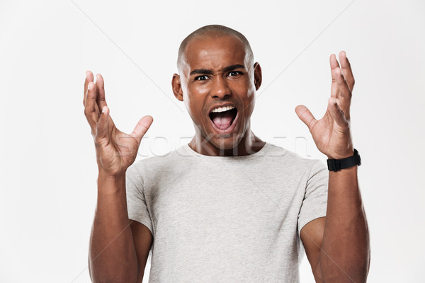 Emotional screaming young african man Stock photo © deandrobot
