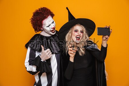 Emotional young women in halloween costumes Stock photo © deandrobot