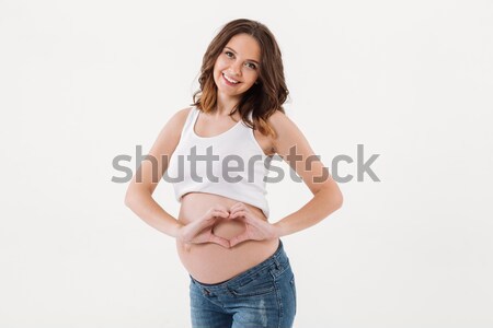 Stockfoto: Glimlachend · zwangere · vrouw · permanente · tonen · hart · liefde