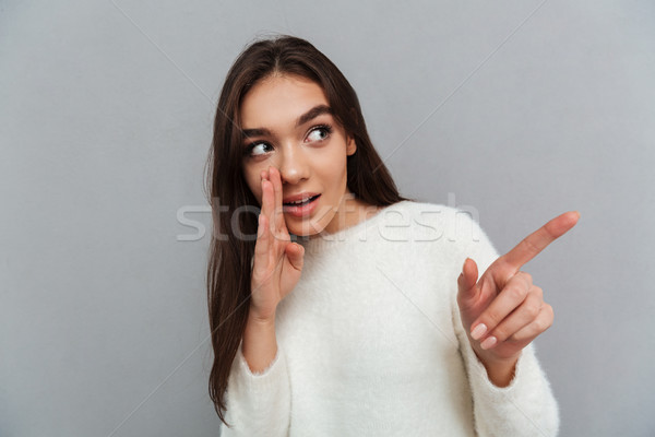 Close-up photo of young attractive woman whispering hot gossips  Stock photo © deandrobot