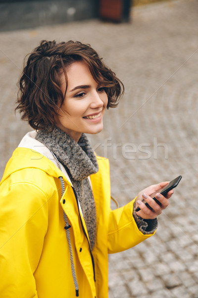 Portrait of beautiful brunette female walking on paving stones h Stock photo © deandrobot