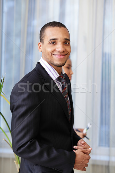 Portrait of a happy African-American young businessman isolated over white background Stock photo © deandrobot