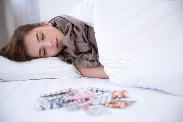 Young beautiful woman sleeping on the bed at home Stock photo © deandrobot