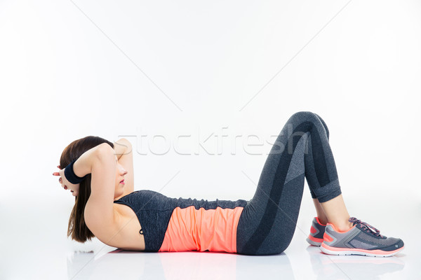 Fitness woman working out on the floor Stock photo © deandrobot