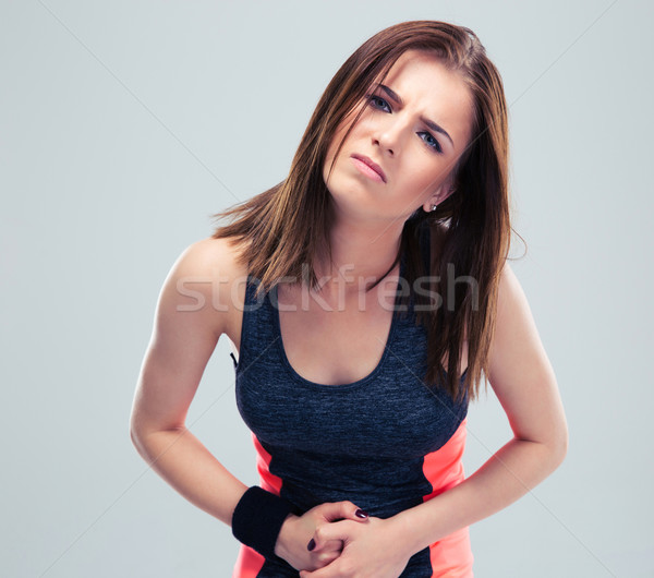 Deportes mujeres dolor estómago gris mirando Foto stock © deandrobot
